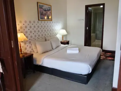 a bedroom with a large white bed in a room at Afrin Service Suits at Berjaya Times Square in Kuala Lumpur