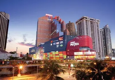 a city skyline with tall buildings and palm trees at Regalia Studio apartment in Kuala Lumpur
