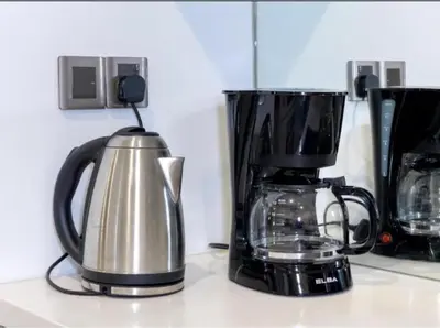 a coffeemaker and a coffee maker on a counter at Vortex suites klcc by 2 bed 3 bed family suites vibes in Kuala Lumpur