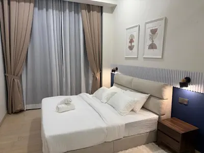 a bedroom with a large white bed and a window at Star Residance KLCC by Nexus in Kuala Lumpur