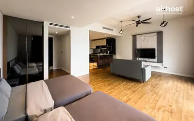 a living room with a couch and a flat screen tv at Anggun Residence KLCC by Airhost in Kuala Lumpur