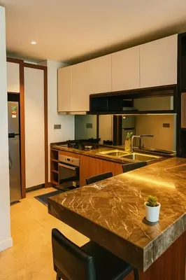 a kitchen with a marble counter top in a room at Anggun Residence KLCC by Airhost in Kuala Lumpur
