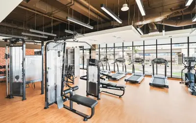 a gym with a row of treadmills and ellipticals at Anggun Residence KLCC by Airhost in Kuala Lumpur