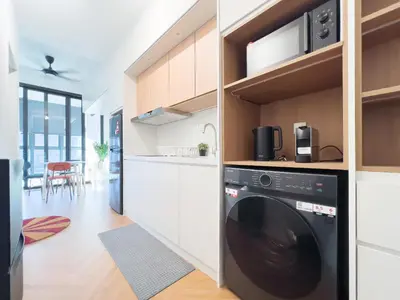 a kitchen with a washer and dryer at Majestic Residence Infinity Pool with KLCC View in Kuala Lumpur