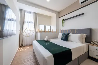 a bedroom with a large bed with a love sign on it at Delightful Studio Suite in Kuala Lumpur