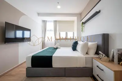 a bedroom with a large bed and a television at Delightful Studio Suite in Kuala Lumpur