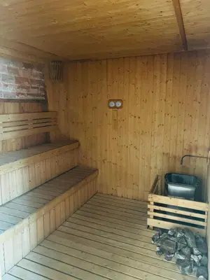 an empty sauna with a bench and a bucket at Axon Suite near Pavilion KL by Sky in Kuala Lumpur