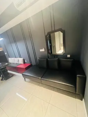 a black couch in a room with a mirror at Axon Suite near Pavilion KL by Sky in Kuala Lumpur