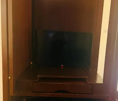 a flat screen tv sitting in a cabinet at Times Square Service Suites By Humira in Kuala Lumpur