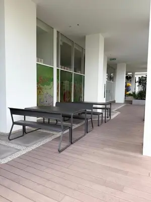 a row of benches sitting inside of a building at Quill Residence by Infinity pool in Kuala Lumpur