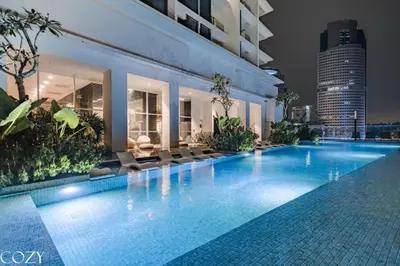 a swimming pool in a building at night at Quill Residence by Infinity pool in Kuala Lumpur