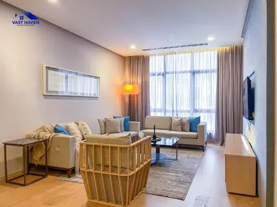 a living room with a couch and a tv at 188 Suites KLCC by VastHaven in Kuala Lumpur