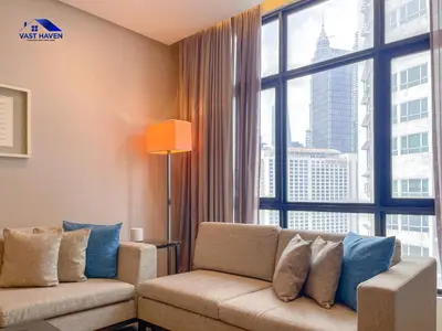 a living room with a couch and a large window at 188 Suites KLCC by VastHaven in Kuala Lumpur