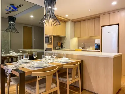 a dining room with a table with wine glasses at 188 Suites KLCC by VastHaven in Kuala Lumpur