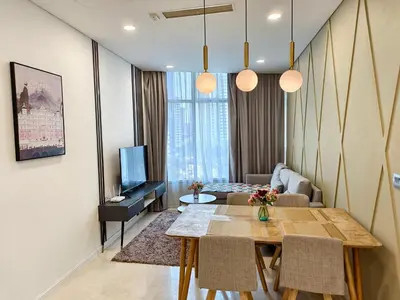 a living room with a table and a living room with a couch at Sky Suites KLCC by Global Family Suites in Kuala Lumpur