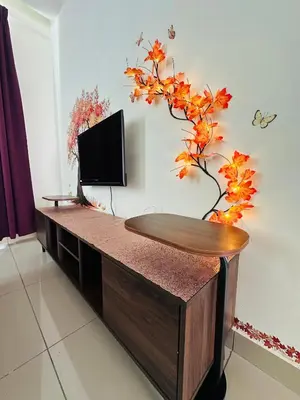 a living room with a tv and a table with a plant at Zetapark Setapak Central Mall Home Sweet Home 3 in Kuala Lumpur