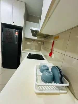 a white dishrack with dishes on a kitchen counter at Zetapark Setapak Central Mall Home Sweet Home 3 in Kuala Lumpur
