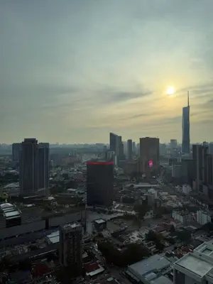 a view of a city skyline with the sun setting at \u5409\u9686\u5761\u96c5\u5c45\u4e50\u5929\u6c47Agile\u56db\u6708\u516c\u5bd3 in Kuala Lumpur