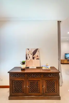 a wooden cabinet in a room with ahibition at 325 Ritchie by COBNB at Ampang in Kuala Lumpur
