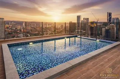 a swimming pool on the roof of a building at Armani Residence KLCC in Kuala Lumpur