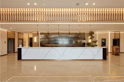a lobby with a reception desk in a building at Armani Residence KLCC in Kuala Lumpur