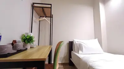 a bedroom with a desk and a bed and a table at Swing and Pillows - ICC Pudu Kuala Lumpur in Kuala Lumpur