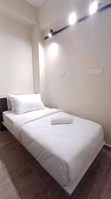 two beds in a room with white walls at Swing and Pillows - ICC Pudu Kuala Lumpur in Kuala Lumpur