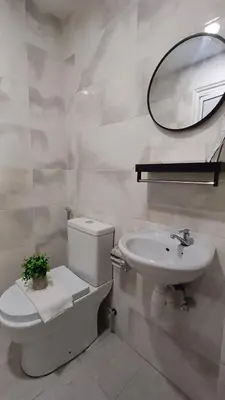 a bathroom with a toilet and a sink and a mirror at Swing and Pillows - ICC Pudu Kuala Lumpur in Kuala Lumpur