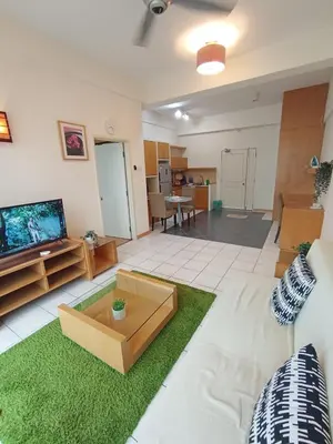 a living room with a couch and a tv at Grand suites at Seri Bukit Ceylon in Kuala Lumpur