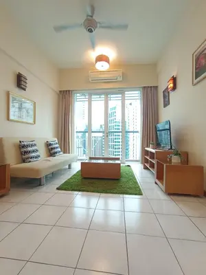 a large living room with a couch and a tv at Grand suites at Seri Bukit Ceylon in Kuala Lumpur