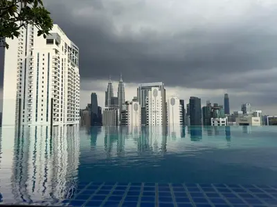 a view of a city skyline from a swimming pool at Kuala Lumpur Majestic Apartment in Kuala Lumpur