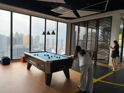 a woman playing a game of pool in a building at Kuala Lumpur Majestic Apartment in Kuala Lumpur
