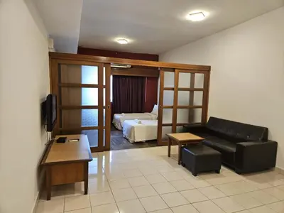 a living room with a couch and a bed at Menara PGRM Suites By VG Homes in Kuala Lumpur