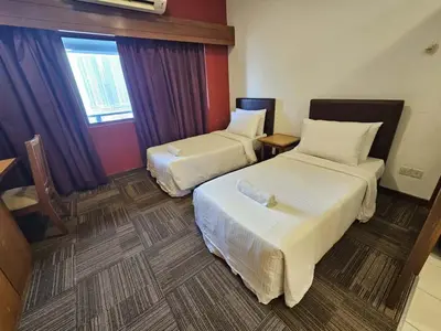 a hotel room with two beds and a window at Menara PGRM Suites By VG Homes in Kuala Lumpur