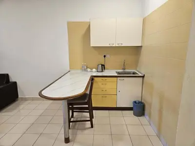 a small kitchen with a table and a sink at Menara PGRM Suites By VG Homes in Kuala Lumpur