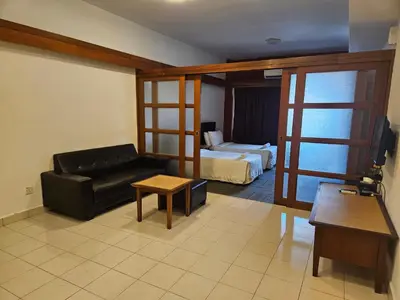 a living room with a couch and a bed at Menara PGRM Suites By VG Homes in Kuala Lumpur