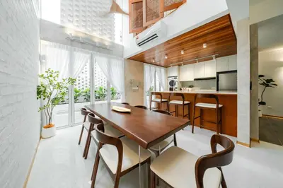 a kitchen and dining room with a wooden table and chairs at Terasek Terrace with Private Pool in Kuala Lumpur
