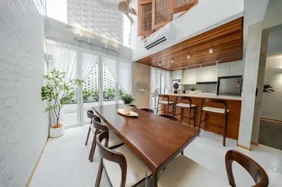 a kitchen and dining room with a wooden table and chairs at Terasek Terrace with Private Pool in Kuala Lumpur