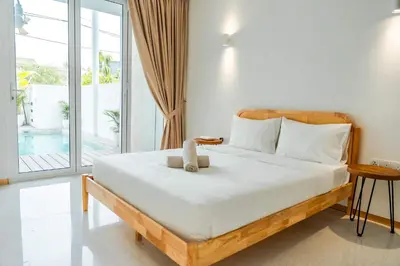 a bedroom with a bed with a teddy bear on it at Terasek Terrace with Private Pool in Kuala Lumpur