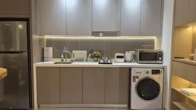 a kitchen with a washing machine and a microwave at Two Bedrooms Bukit Bintang Agile TRX Pavillion Nature Home Netflix Good View #33 in Kuala Lumpur