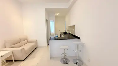 a white living room with a couch and a table at majestic Resort Suites KLCC At Bukit bintang in Kuala Lumpur
