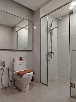 a bathroom with a toilet and a glass shower at Agile Delima Homestay Premium Suites at TRX BUKIT BINTANG in Kuala Lumpur