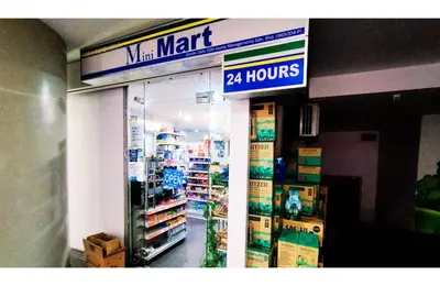 a store with a mart hours sign in a store at Taragon Elite Residence in Kuala Lumpur