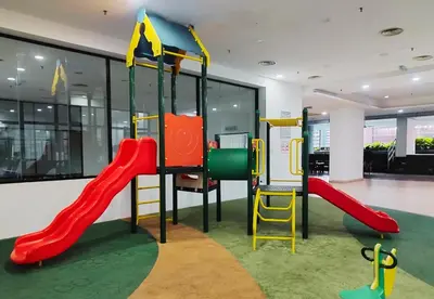 a childrens play area with a slide and a playground at Taragon Elite Residence in Kuala Lumpur