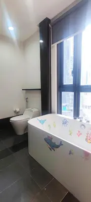 a bathroom with a tub and a toilet and a sink at The Mews KLCC by Luxe Residence in Kuala Lumpur