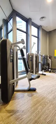 a gym with several tread machines in a room at The Mews KLCC by Luxe Residence in Kuala Lumpur