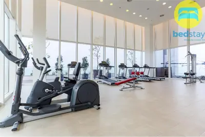 a gym with treadmills and ellipticals in a building at Elysian Sky Executive Platinum Suites KLCC in Kuala Lumpur