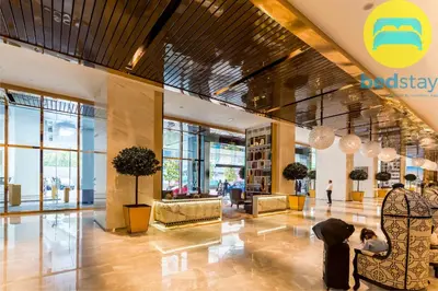 a lobby of a building with a person sitting in a chair at Elysian Sky Executive Platinum Suites KLCC in Kuala Lumpur