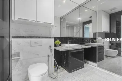 a bathroom with a toilet and a sink and a mirror at Elysian Sky Executive Platinum Suites KLCC in Kuala Lumpur
