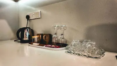 a counter with a tray of glass bottles on it at Eaton Residence KLCC - J Home in Kuala Lumpur